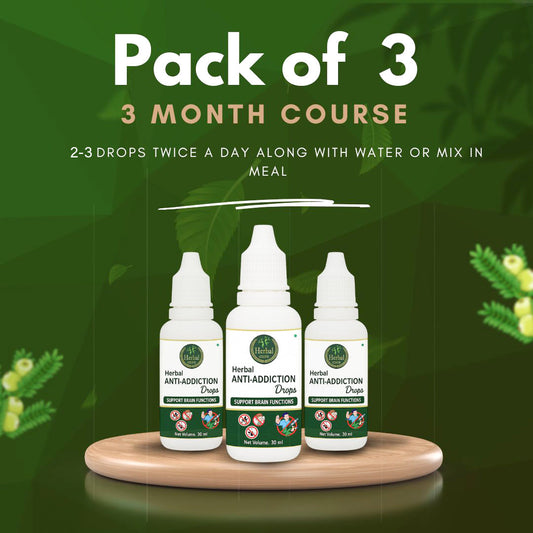 Three bottles of Anti Addiction Drops placed on a wooden surface 